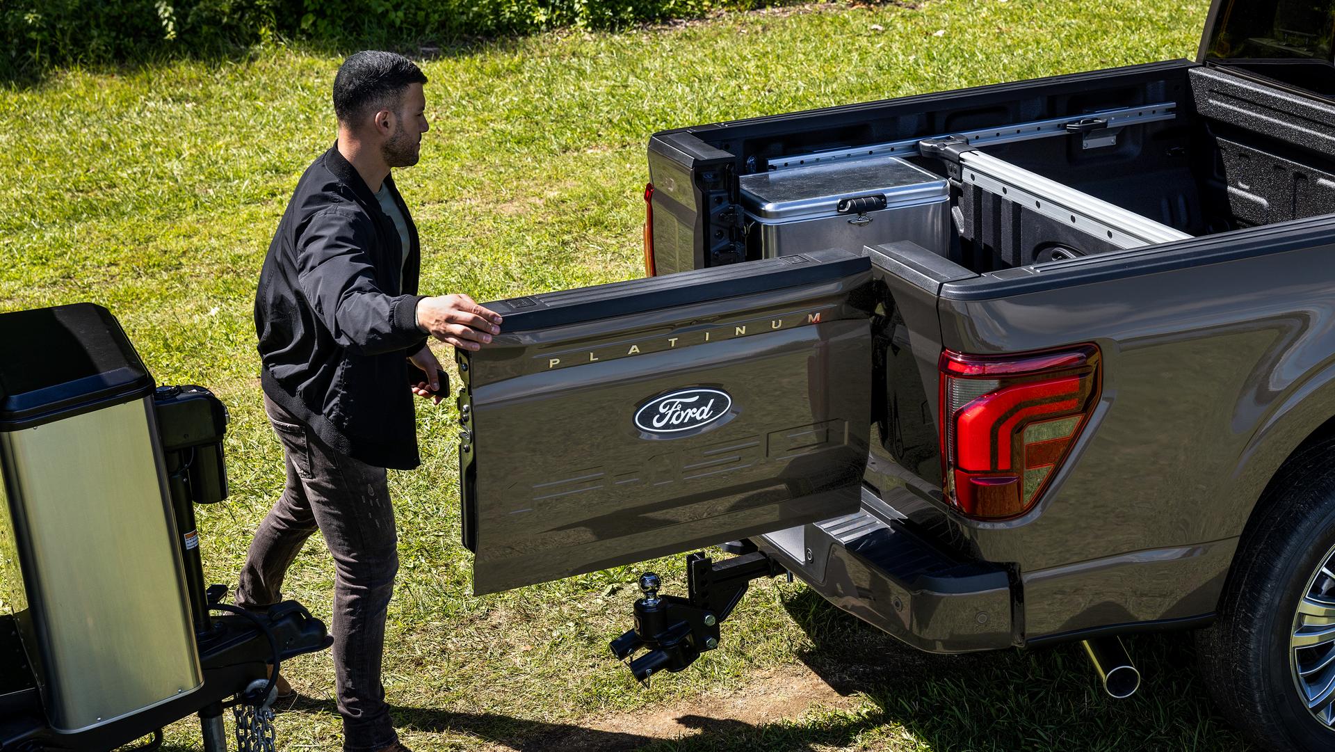 Man using the Pro Access Tailgate feature on a 2026 Ford F-150® Platinum® model