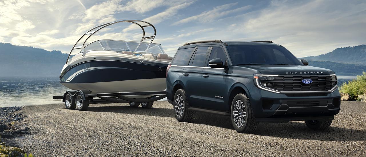 2027 Ford Expedition® model with a driver towing a boat on a trailer