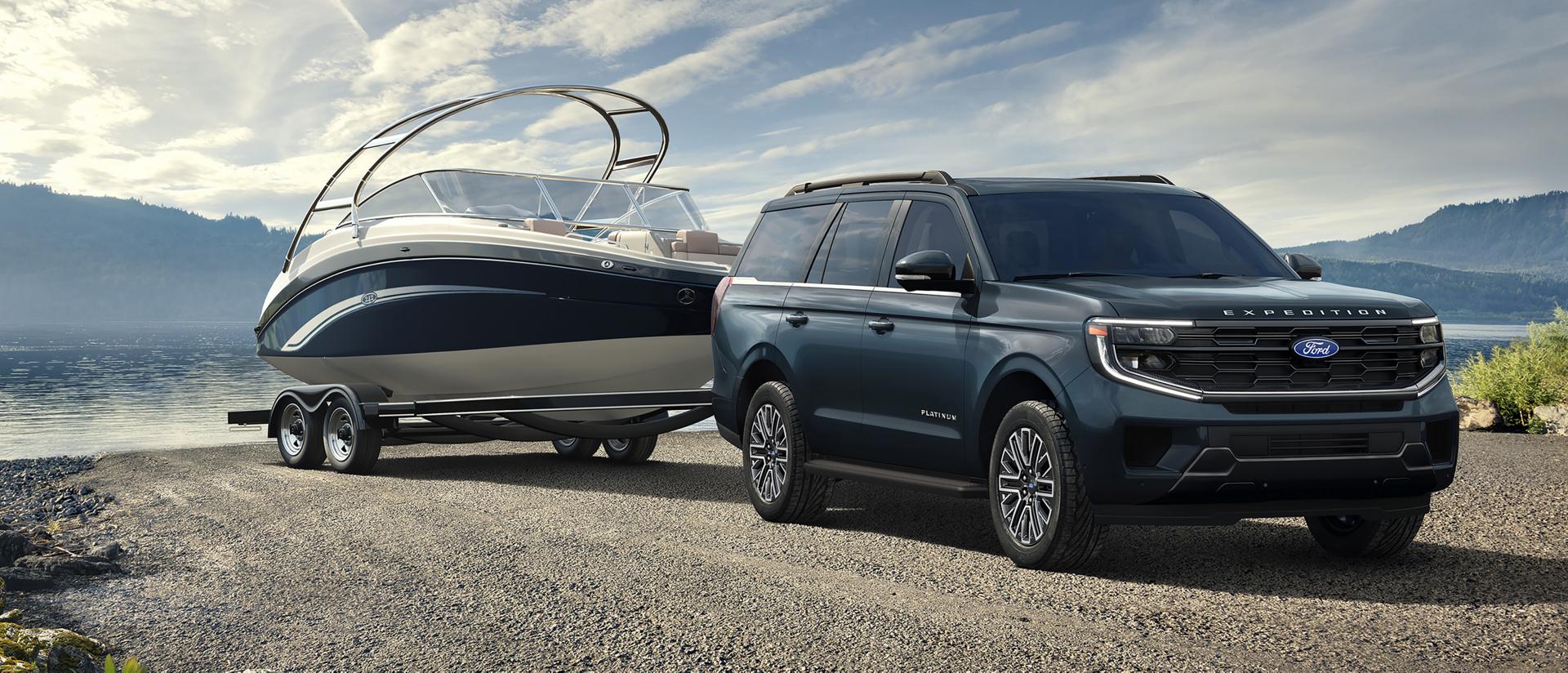2027 Ford Expedition® Platinum™ SUV with a driver towing a boat on a trailer