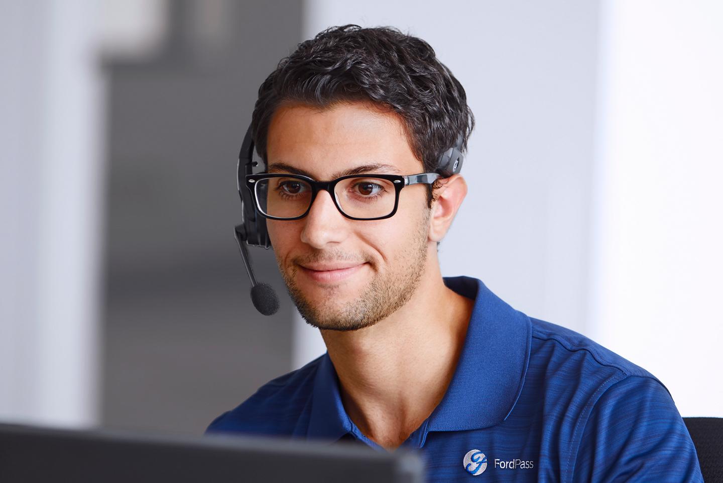 A call centre agent looks at a computer monitor.