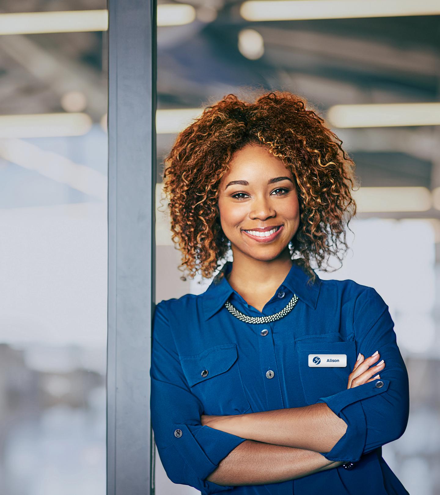 A smiling Ford employee wearing a blue shirt.