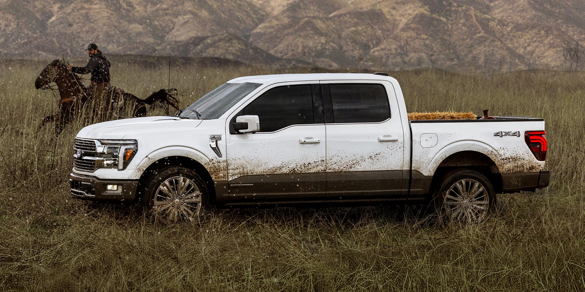 A person horseback riding next to a dirty 2025 Ford F-150® truck.