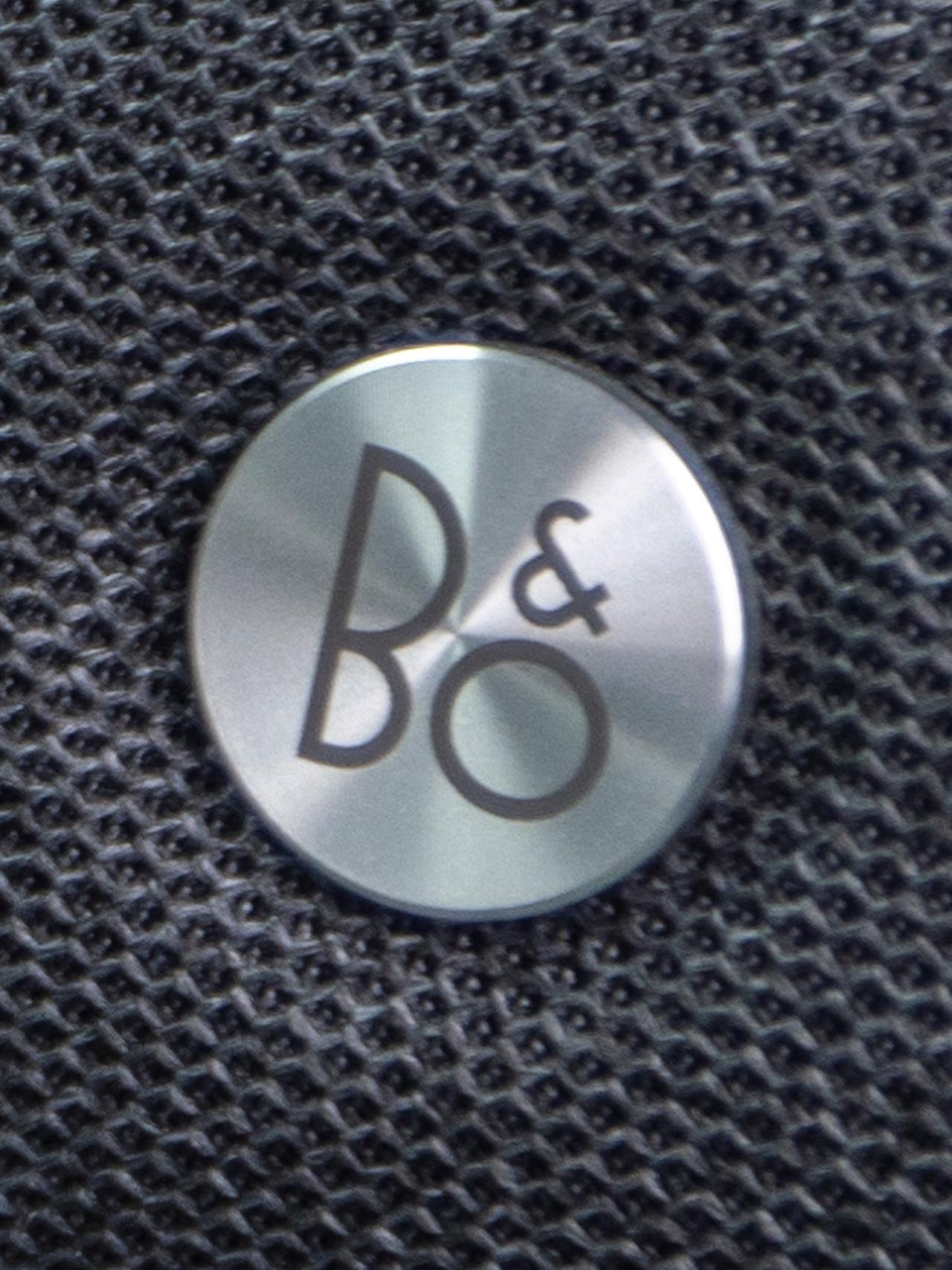 A close-up of the B&O® logo on a speaker in a 2027 Ford Explorer® SUV