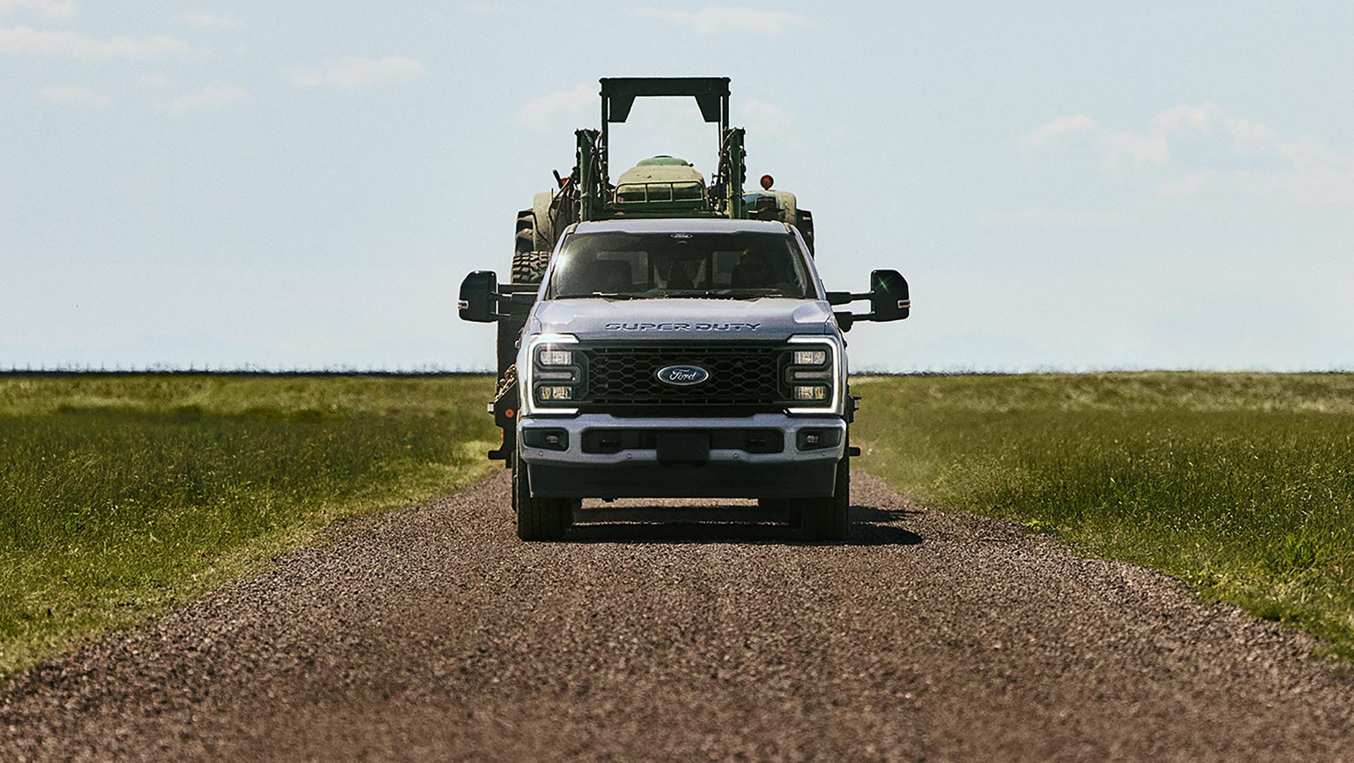 Super Duty driving down a dirt road.