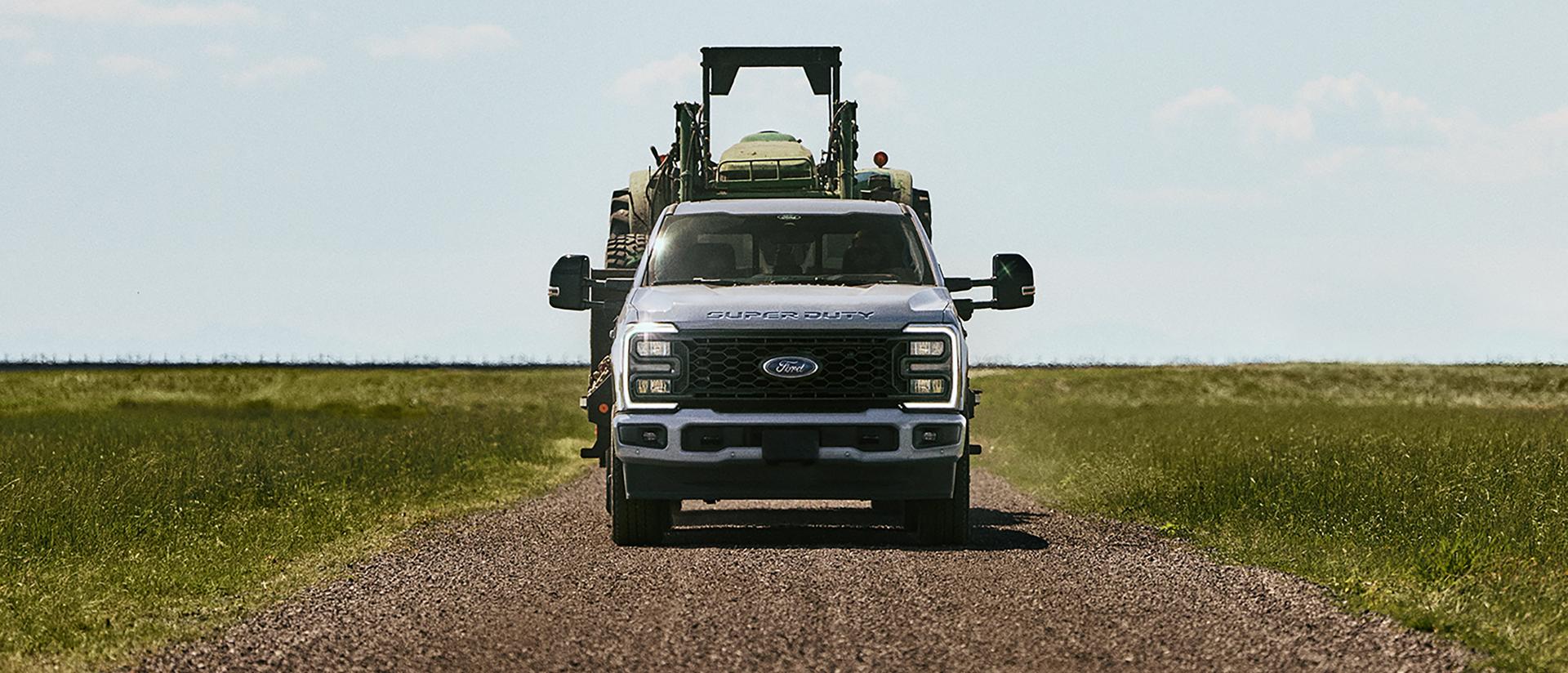 Super Duty driving down a dirt road.