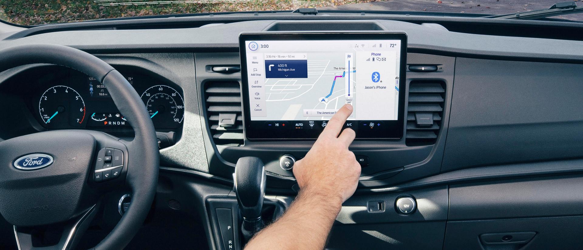 Interior of a 2025 Ford Transit® Van with a person interacting with the touchscreen