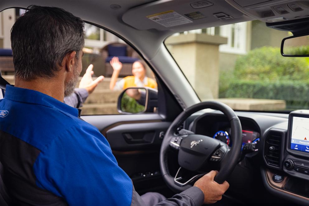 A Ford service technician arrives at the home of a Ford owner.