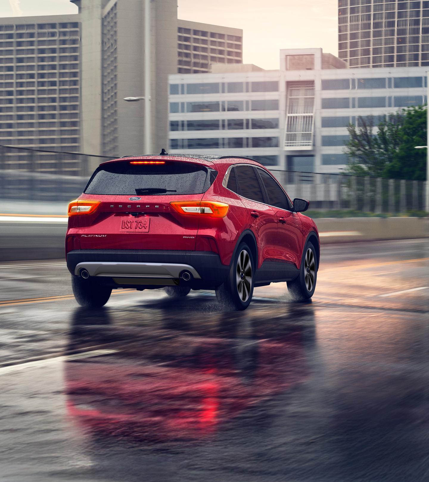 Ford Escape driving on an urban highway.