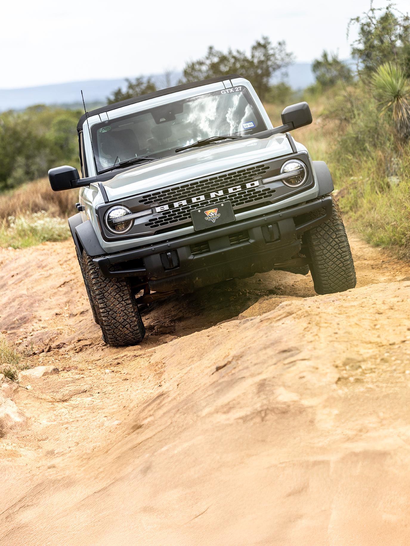Ford Bronco driving on rugged terrain.