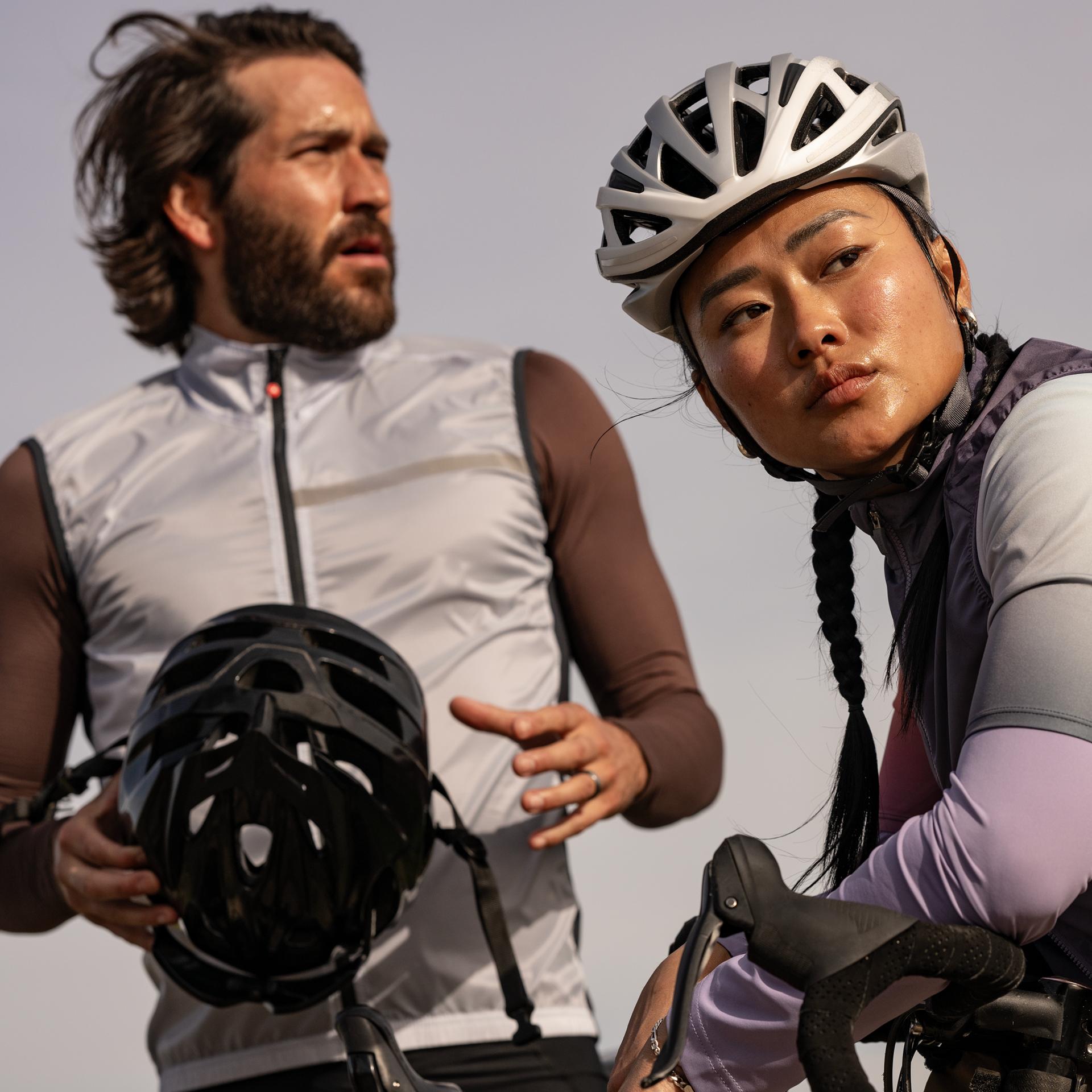 Two cyclists standing near their bicycles