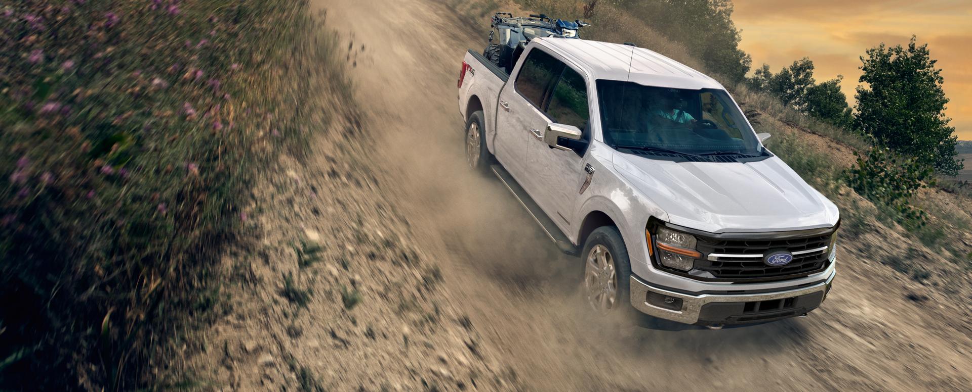 2025 Ford F150® PowerBoost® Hybrid pickup being driven on an open road