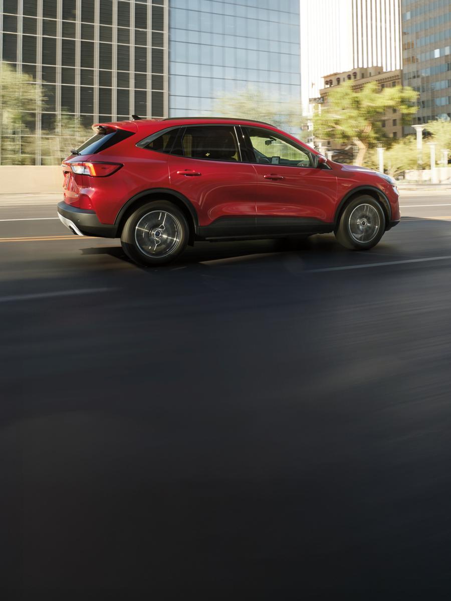 Ford Escape driving on an urban road.