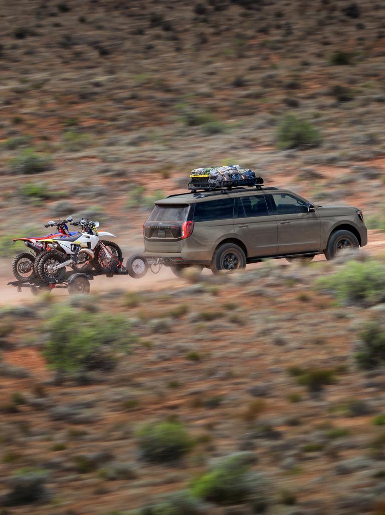 2026 Ford Expedition® Tremor® SUV towing a dirt bike trailer in the desert