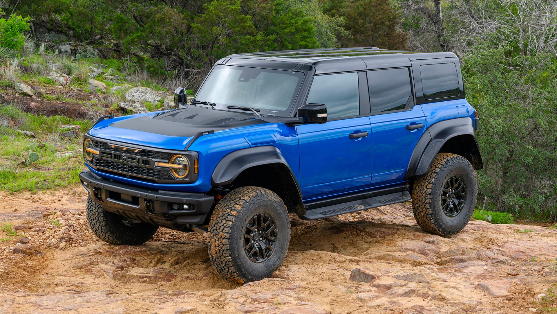 A 2026 Ford Bronco® Raptor® SUV with the available Raptor Black Appearance Package parked on a muddy hilltop in the forest