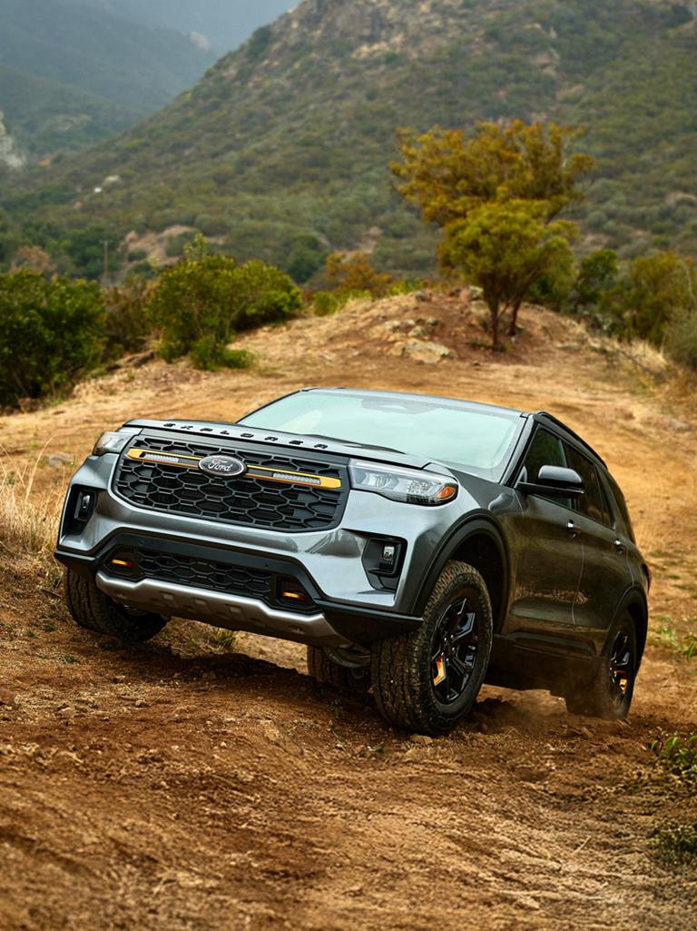 A 2026 Ford Explorer® Tremor® model climbing a grassy hillside