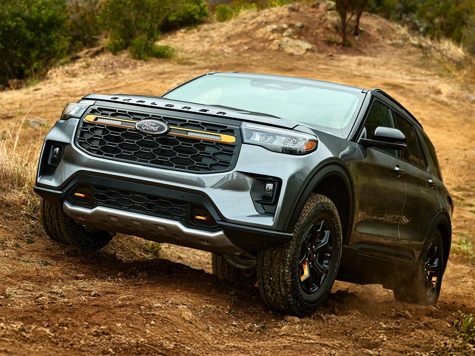 A 2026 Ford Explorer® Tremor® model climbing a grassy hillside