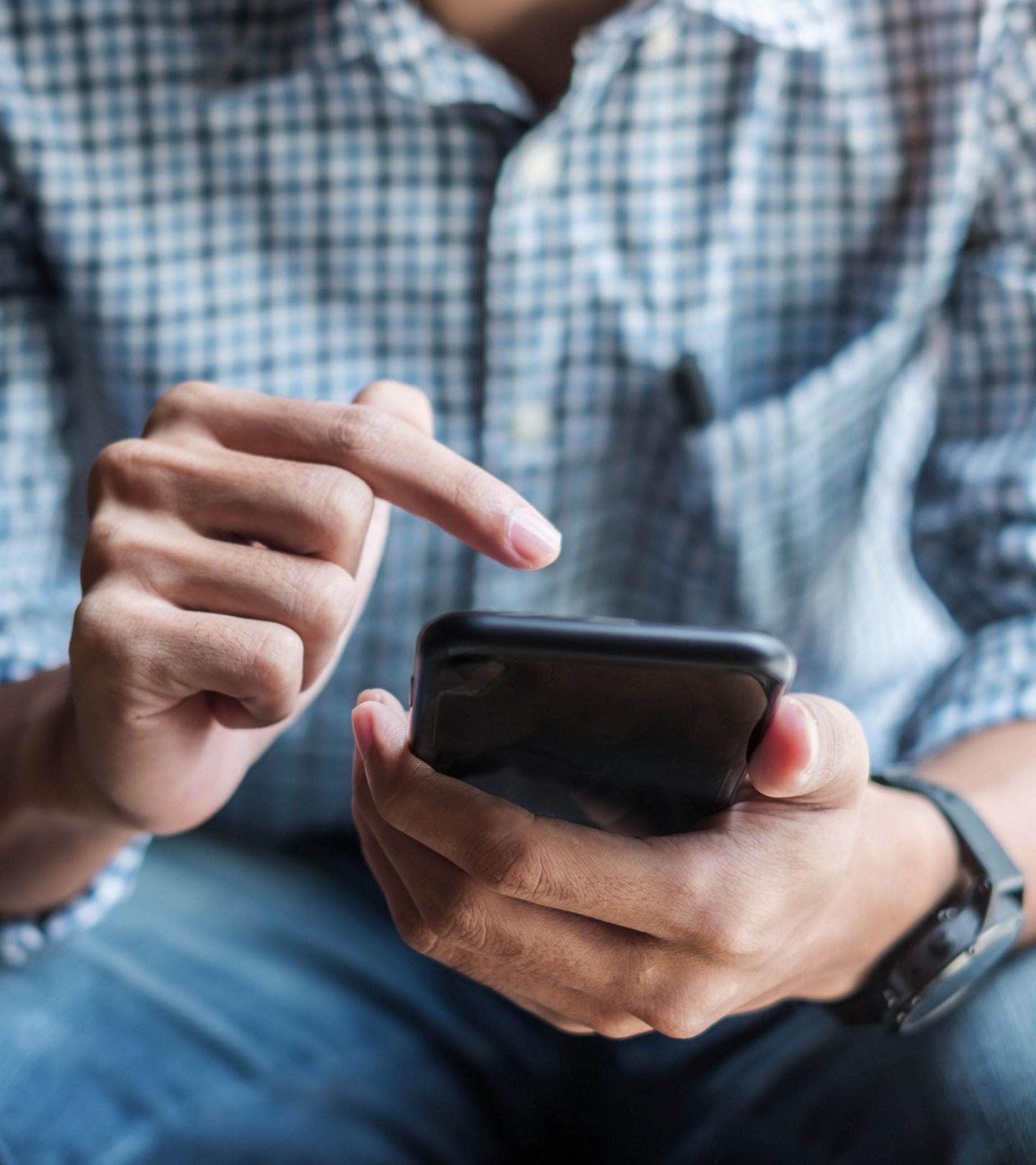 Person looking at a smartphone.