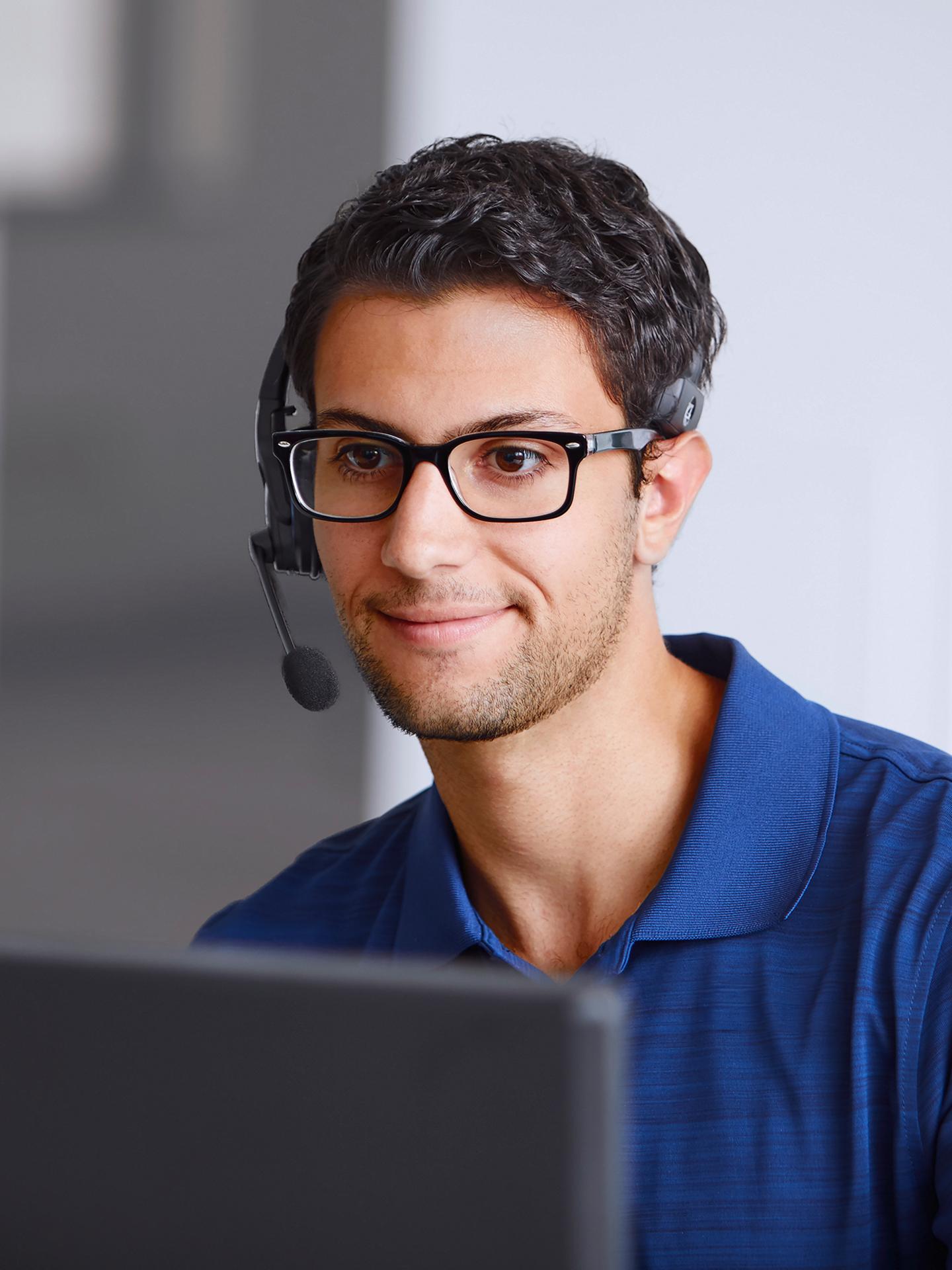 A Ford customer service agent wearing a headset.