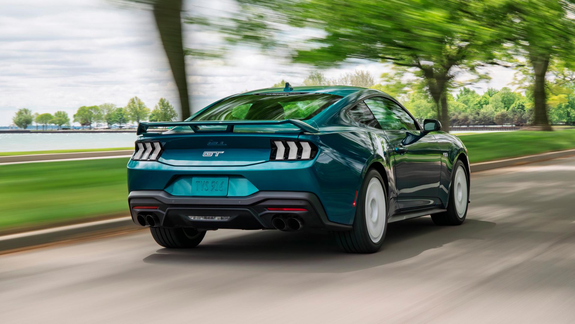 A 2026 Ford Mustang® GT Premium with the available Mustang FX® Package being driven near a lake