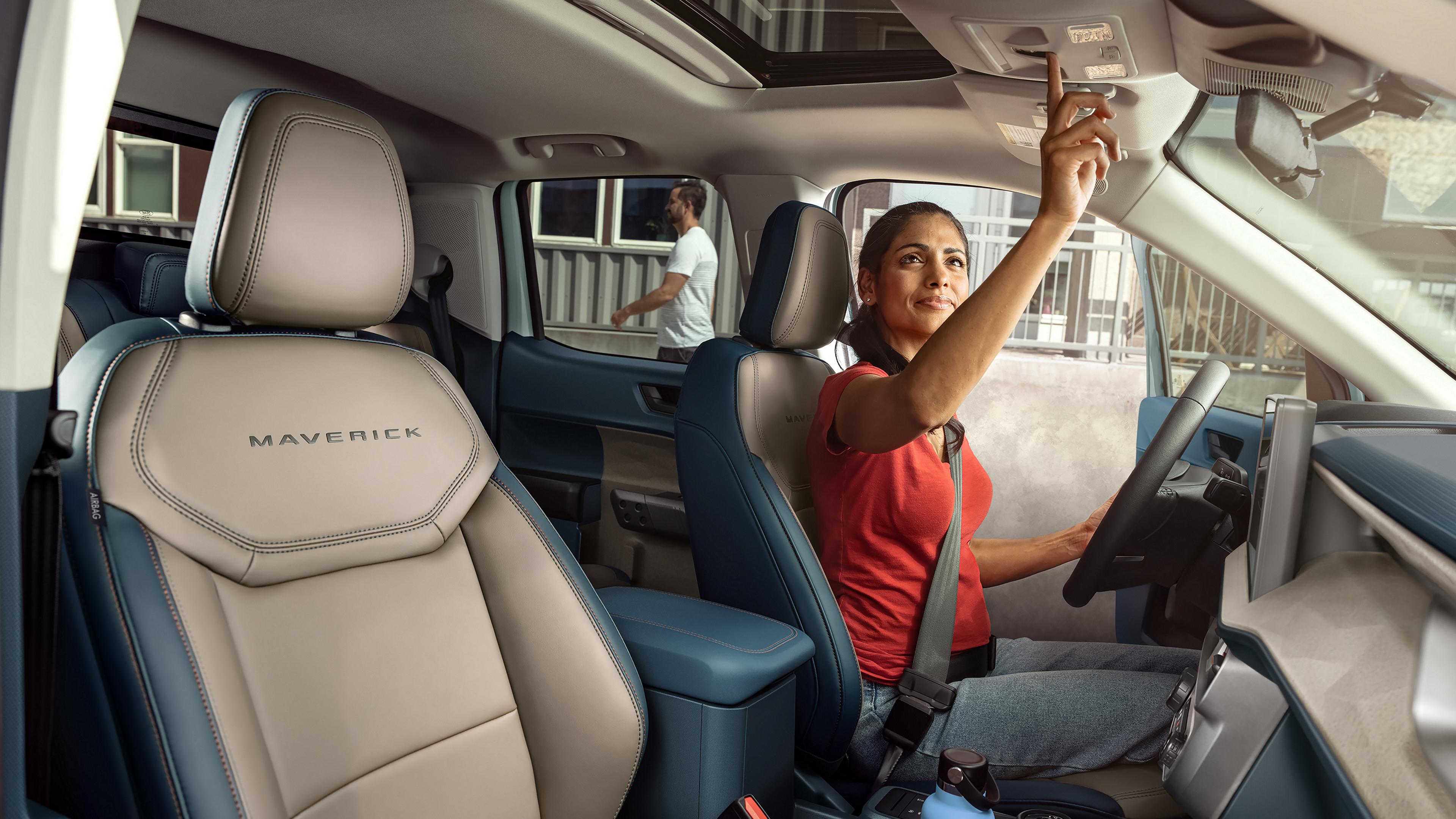 Woman using the moonroof controls of a 2026 Ford Maverick® Lariat® pickup