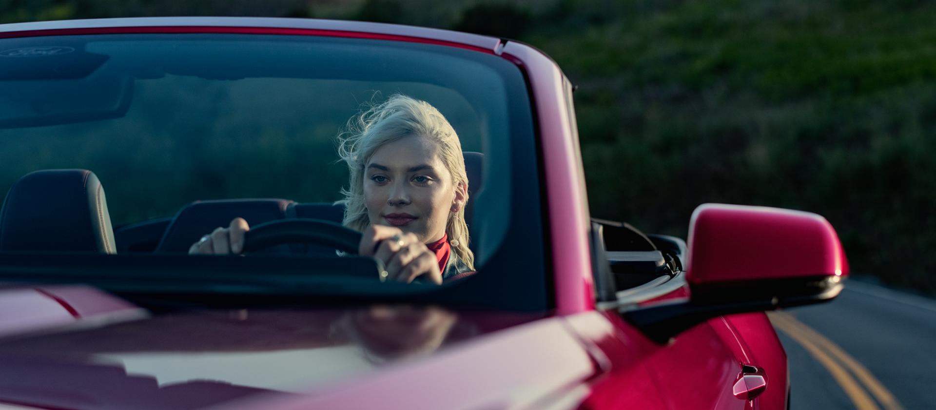 Person driving a 2025 Ford Mustang® GT Convertible on a highway