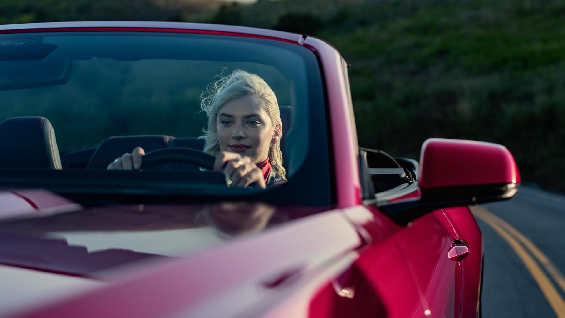 Person driving a 2025 Ford Mustang® GT Premium Convertible on a highway