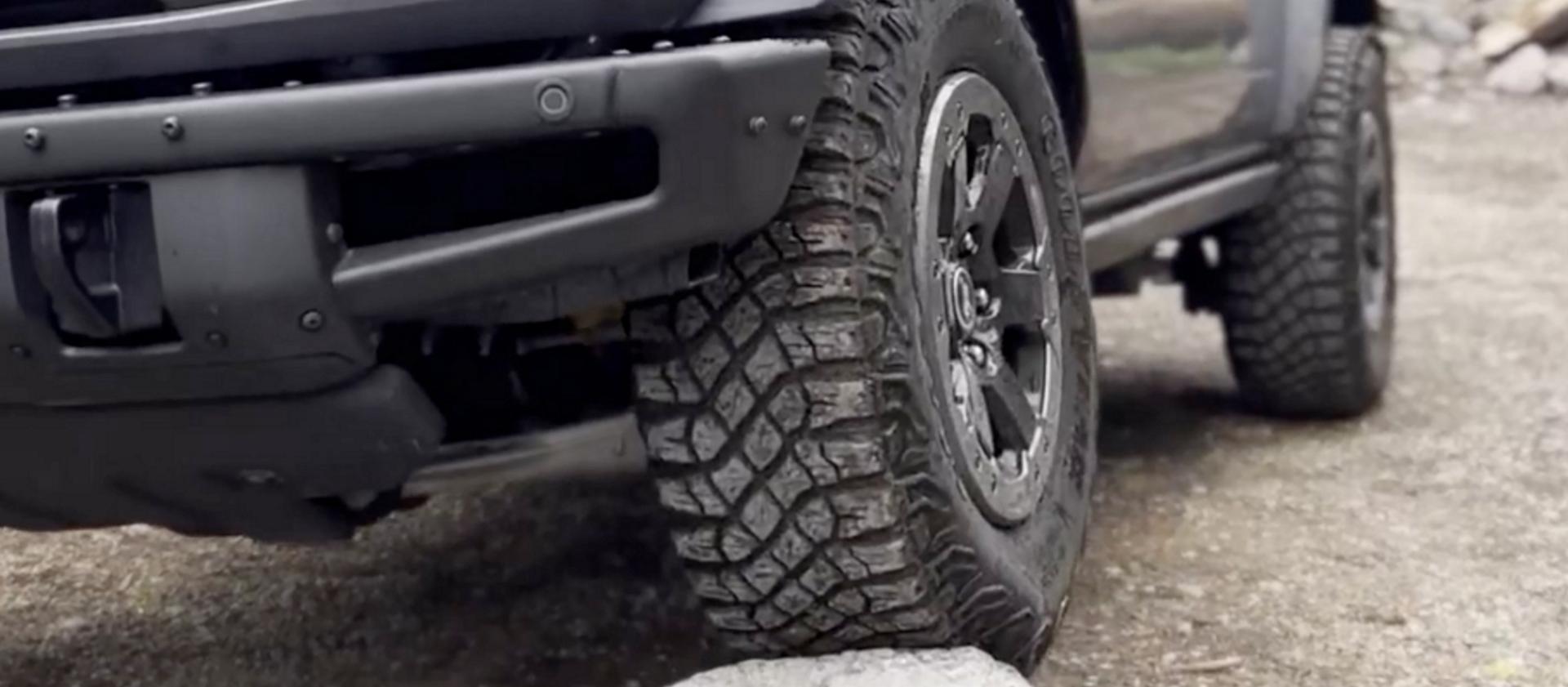 A 2026 Ford Bronco® SUV being driven onto a large boulder
