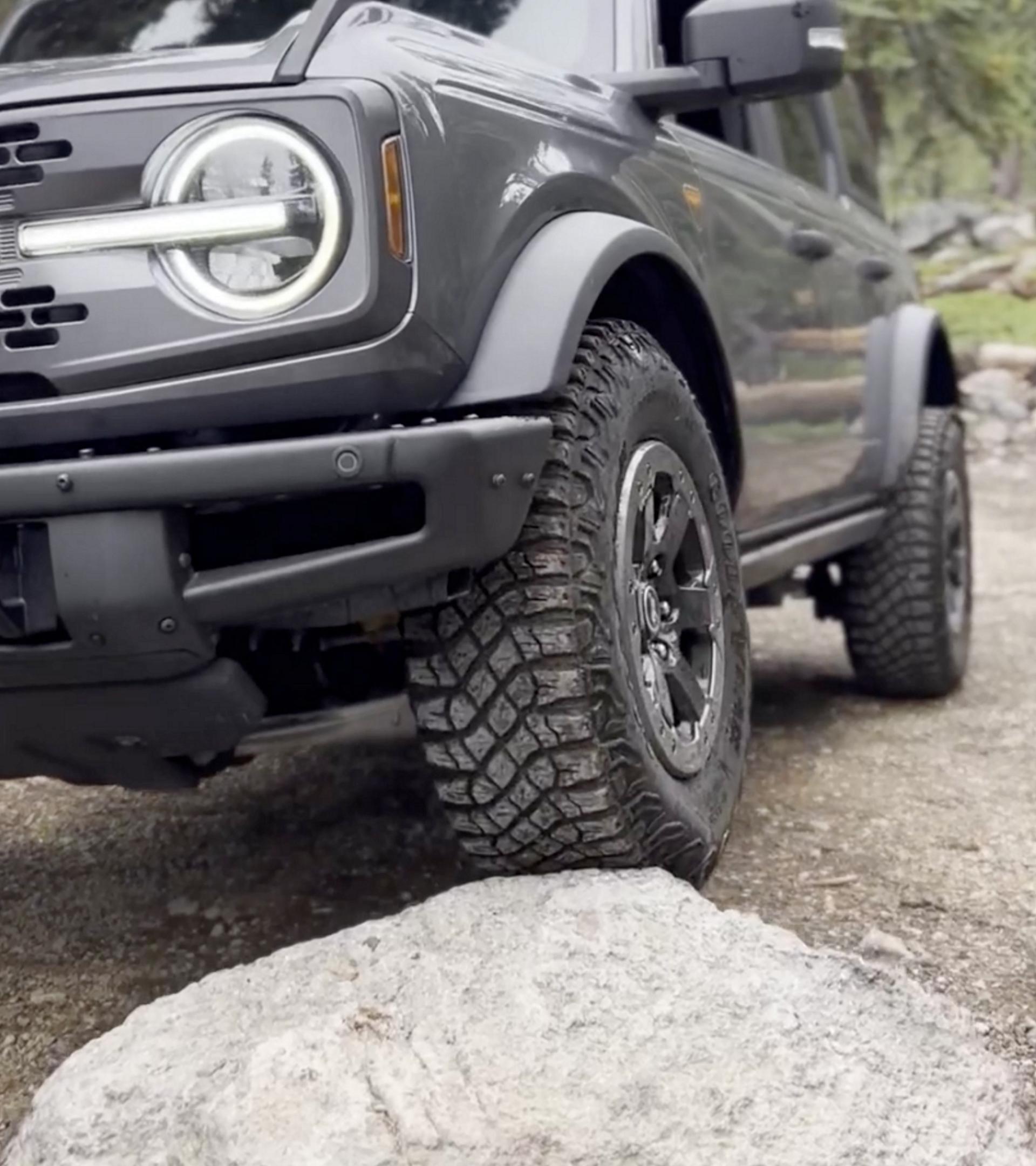 A 2026 Ford Bronco® SUV being driven onto a large boulder