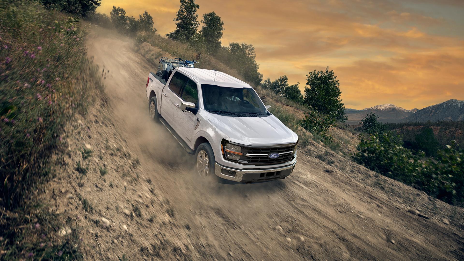 2026 Ford F-150® FX4 model being driven down a steep slope on a dirt road