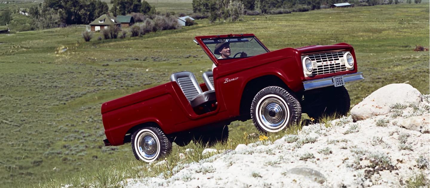 1960s Bronco Roadster driving uphill.