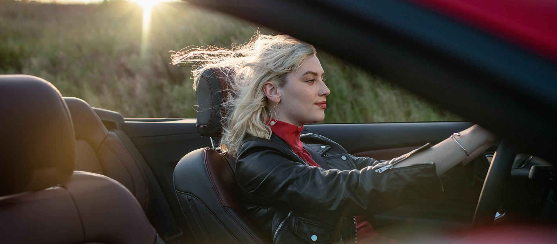 Person driving a 2026 Ford Mustang® GT convertible on a highway