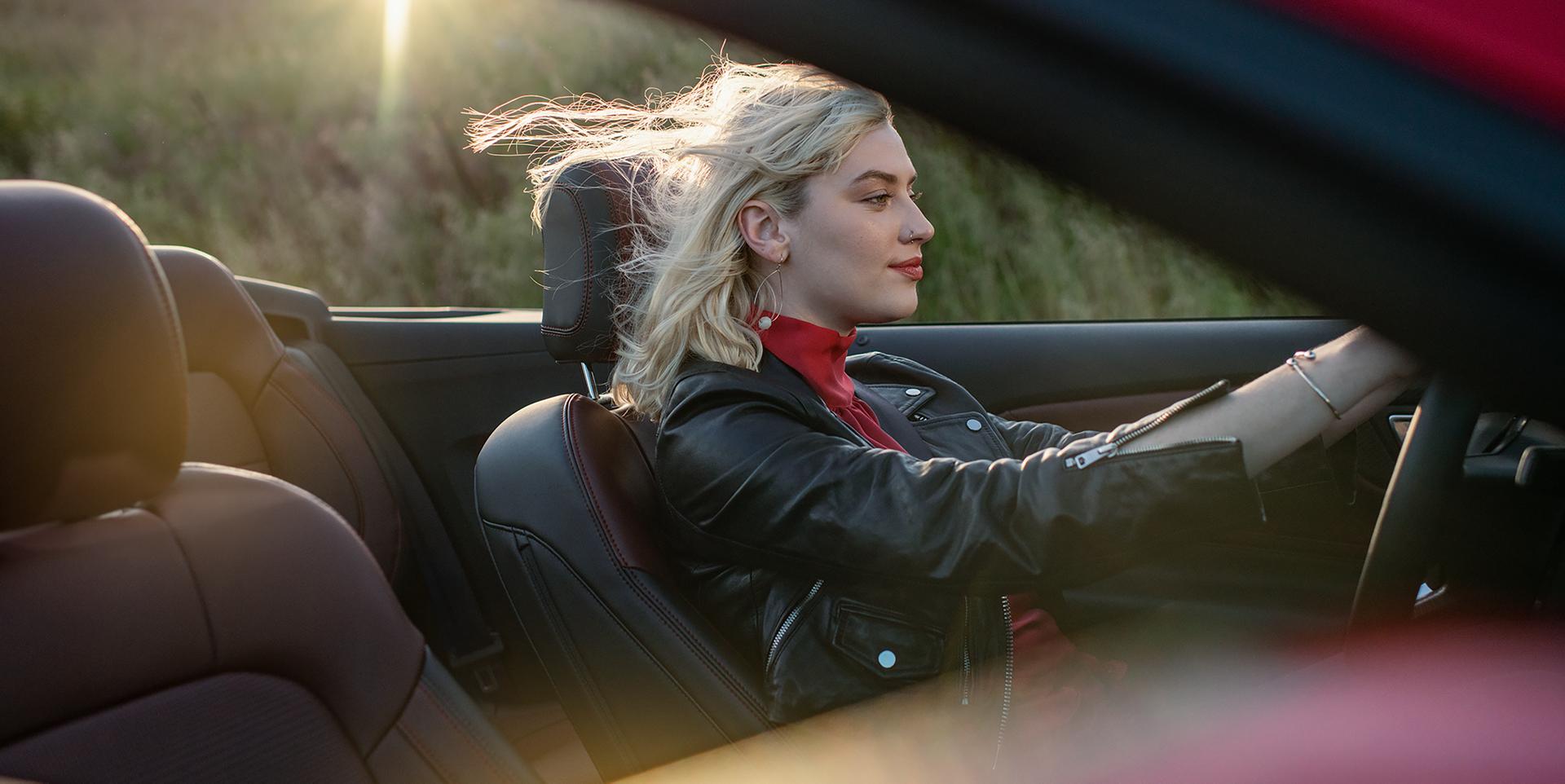 Person driving a 2026 Ford Mustang® GT convertible on a highway