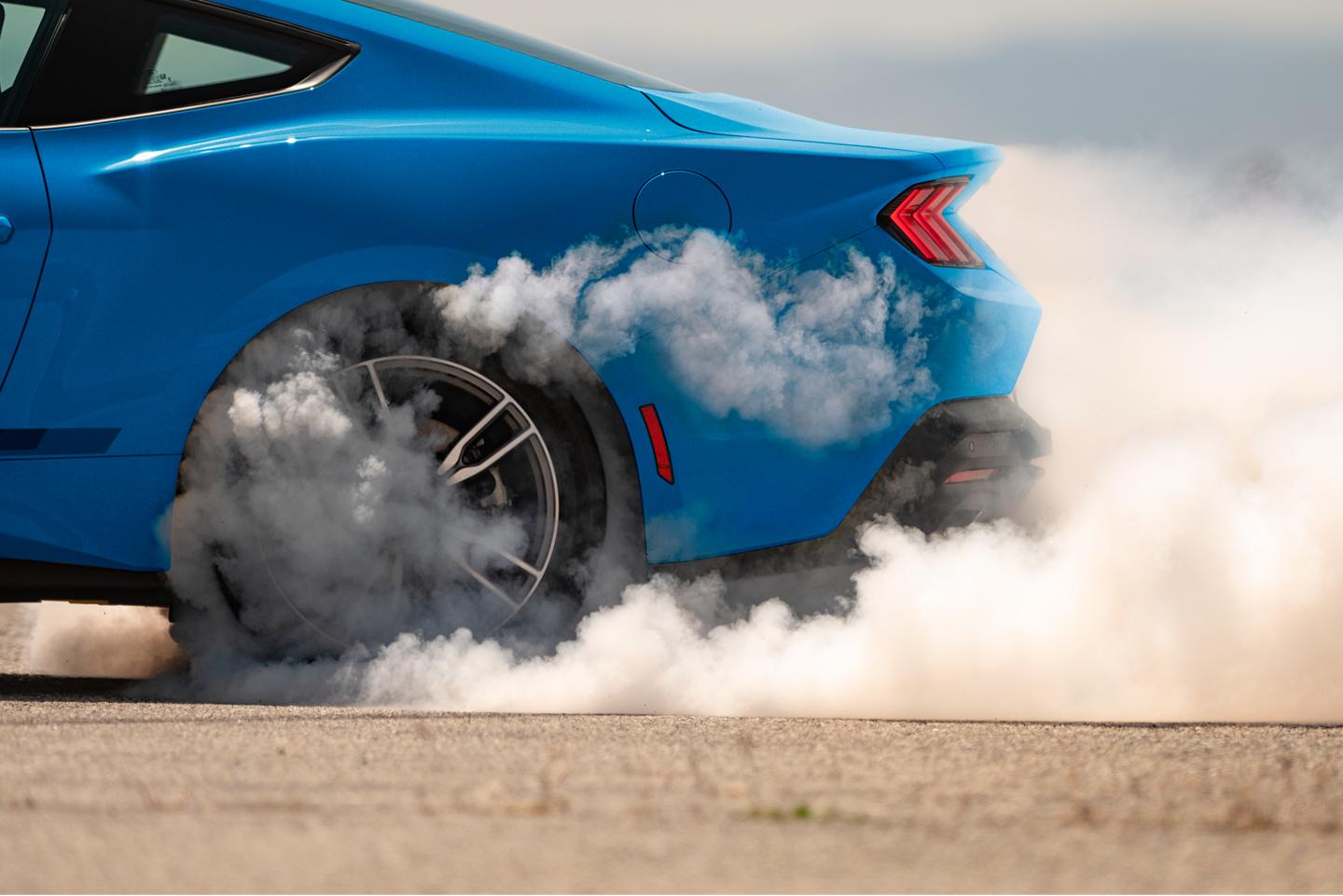Mustang with smoking tires.