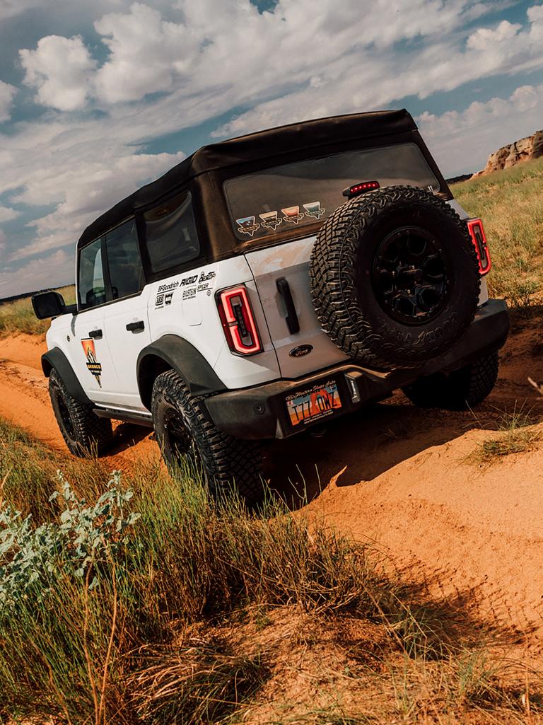 A 2026 Ford Bronco® SUV being driven on a dirt path in Moab, Utah