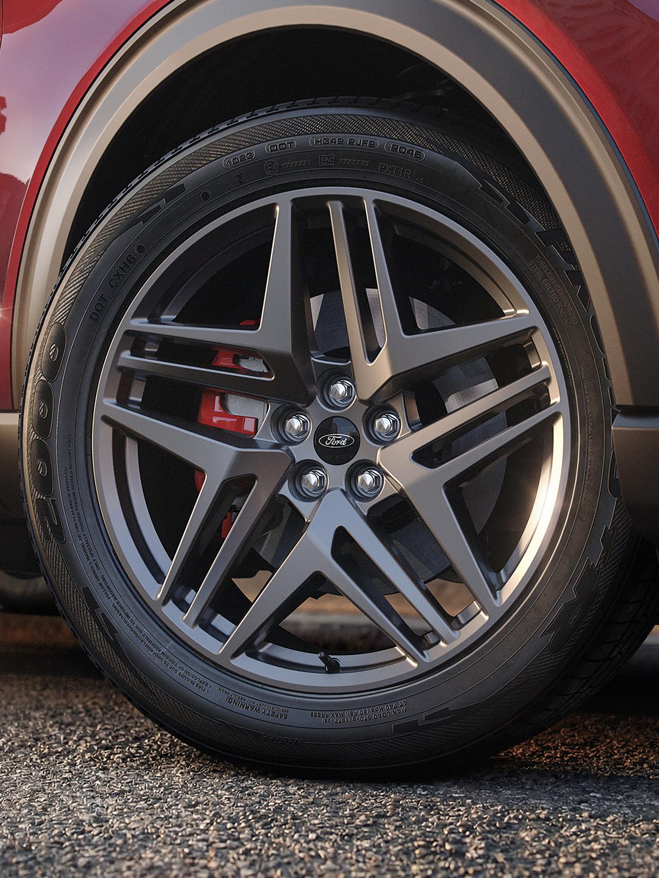 The front wheel and red-painted brake calipers on a 2027 Ford Explorer® ST-Line model with available Street Pack